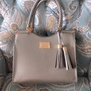 NWOT BEBE Tote/Handbag silvery gray with gold accents and a tassel